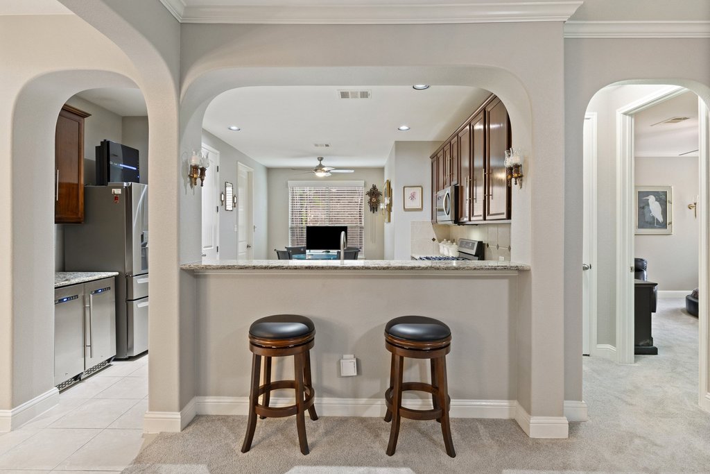 10800 Desert Willow Loop Austin, TX 78748 - Photo 11 of 36 a kitchen with stainless steel appliances granite countertop a refrigerator and a table