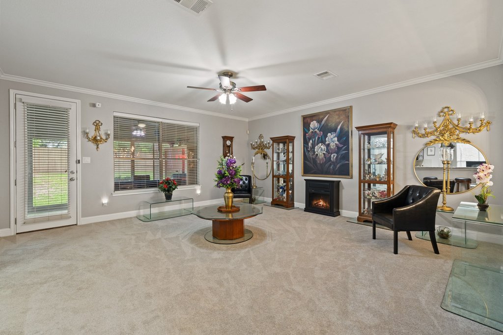 10800 Desert Willow Loop Austin, TX 78748 - Photo 13 of 36 a living room with furniture a fireplace and a window
