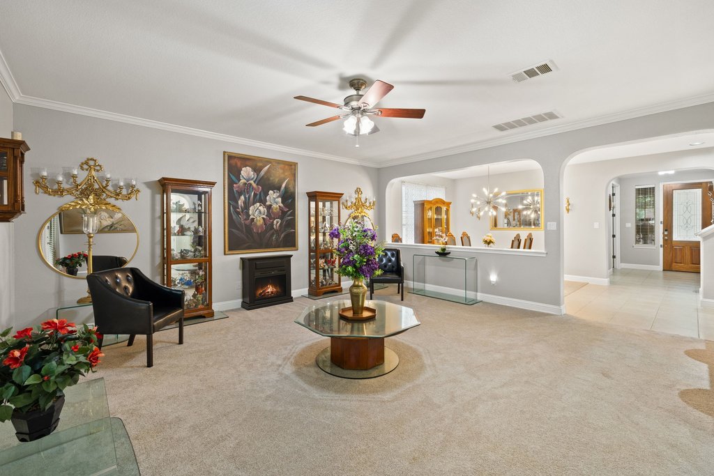 10800 Desert Willow Loop Austin, TX 78748 - Photo 15 of 36 a living room with fireplace furniture and a chandelier