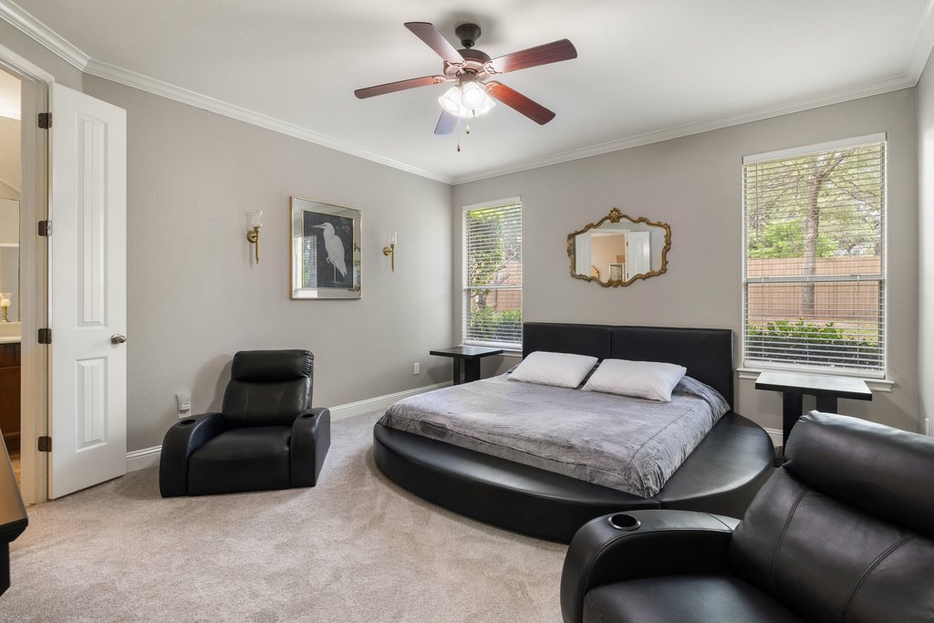 10800 Desert Willow Loop Austin, TX 78748 - Photo 16 of 36 a bedroom with a bed and a chandelier