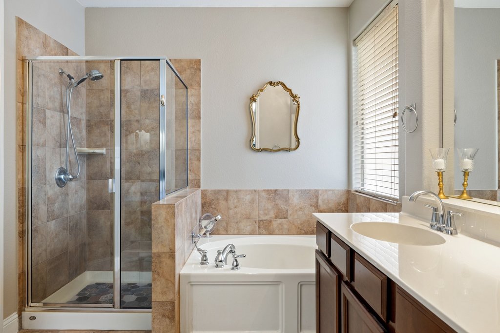 10800 Desert Willow Loop Austin, TX 78748 - Photo 19 of 36 a bathroom with a sink vanity tub and shower
