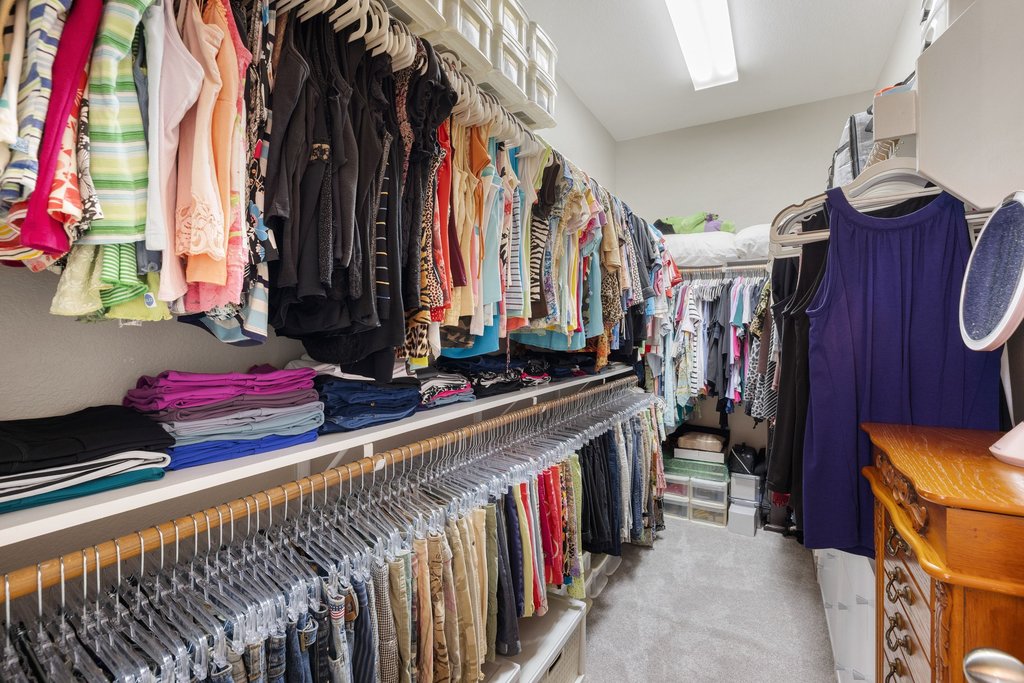 10800 Desert Willow Loop Austin, TX 78748 - Photo 21 of 36 a view of walk in closet with clothes and shoes