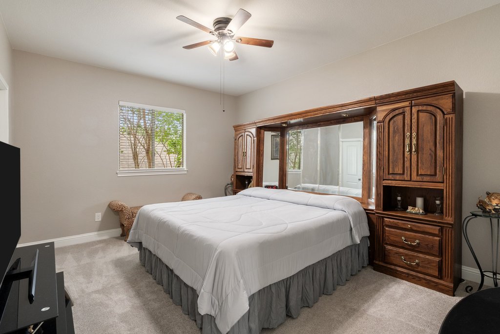 10800 Desert Willow Loop Austin, TX 78748 - Photo 27 of 36 a bedroom with a bed lamps and dresser