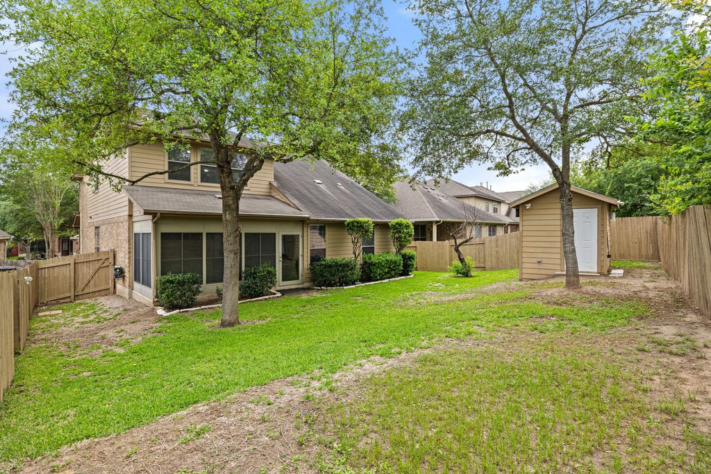 10800 Desert Willow Loop Austin, TX 78748 - Photo 35 of 36 a front view of a house with a garden and trees