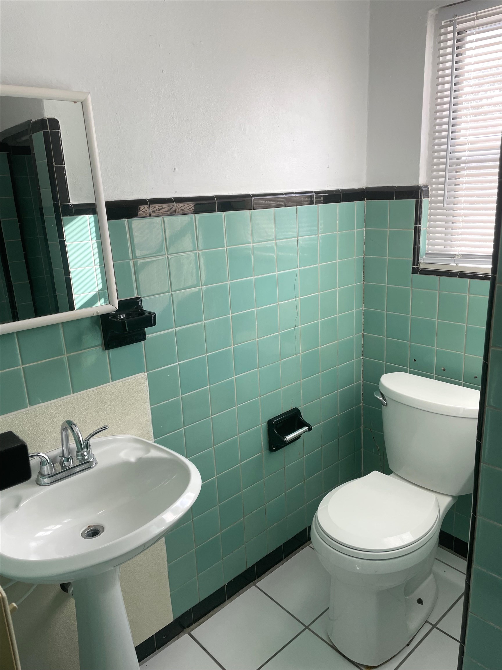 147 D Riberia Street St. Augustine, FL 32084 - Photo 8 of 9 a bathroom with a sink a toilet and a mirror