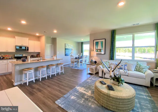 a dining room with furniture a chandelier and wooden floor