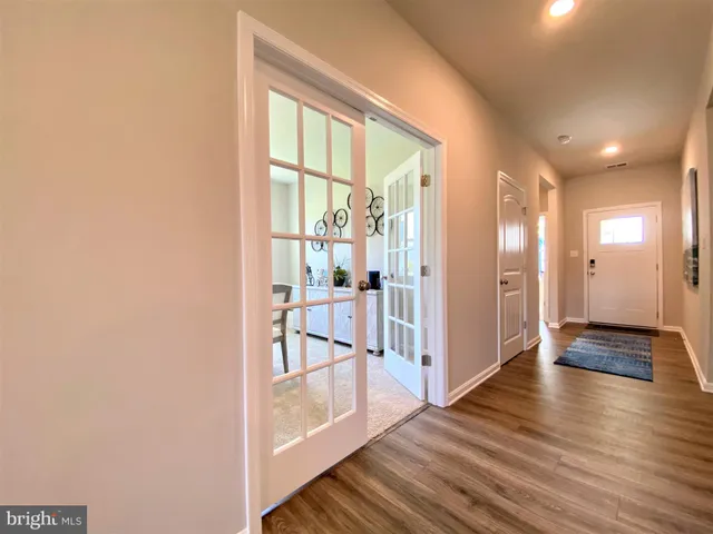 a kitchen that has a lot of cabinets a sink and appliances in it