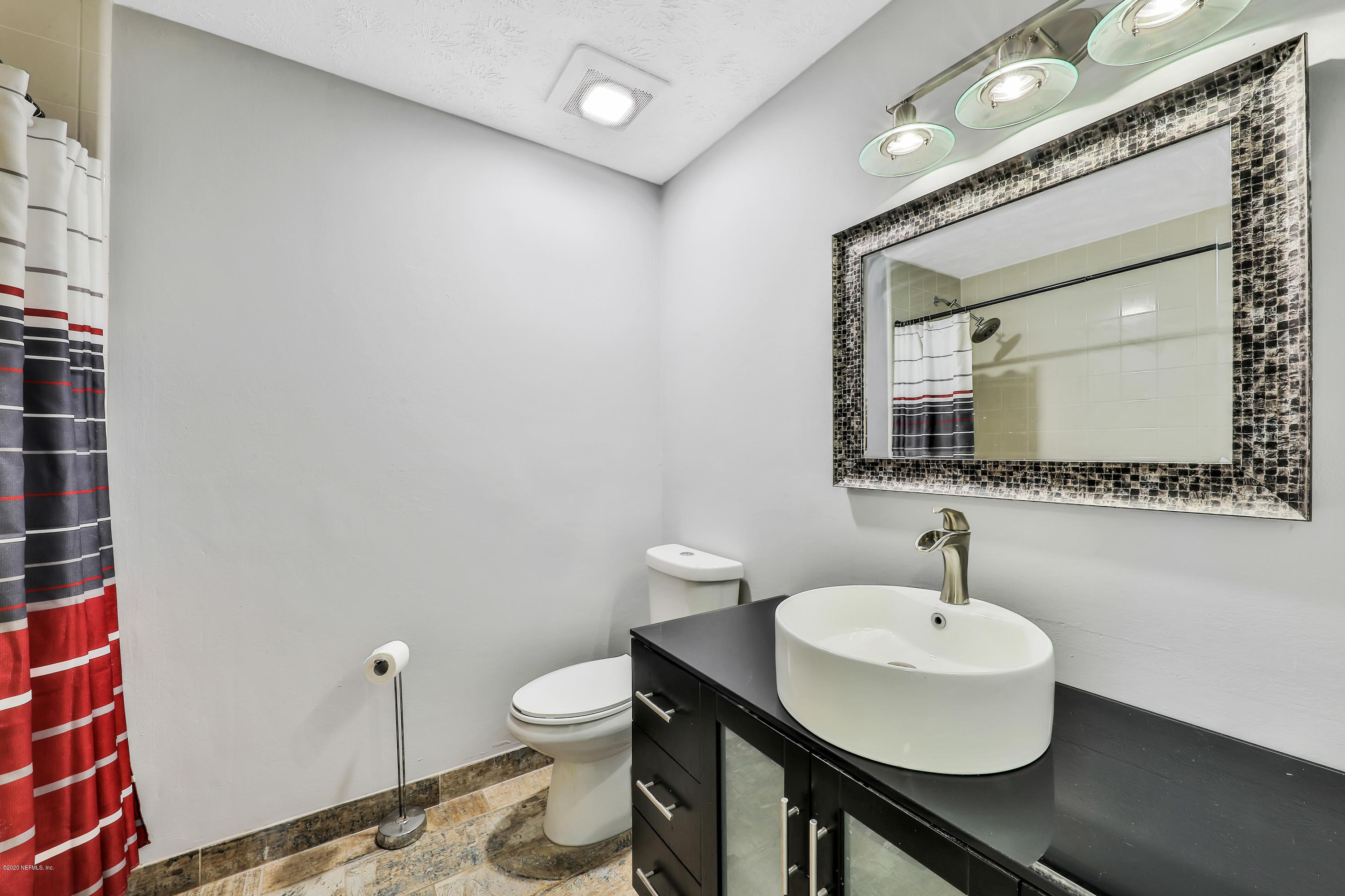 54668 Dornbush Road Callahan, FL 32011 - Photo 16 of 22 a bathroom with a toilet sink and mirror