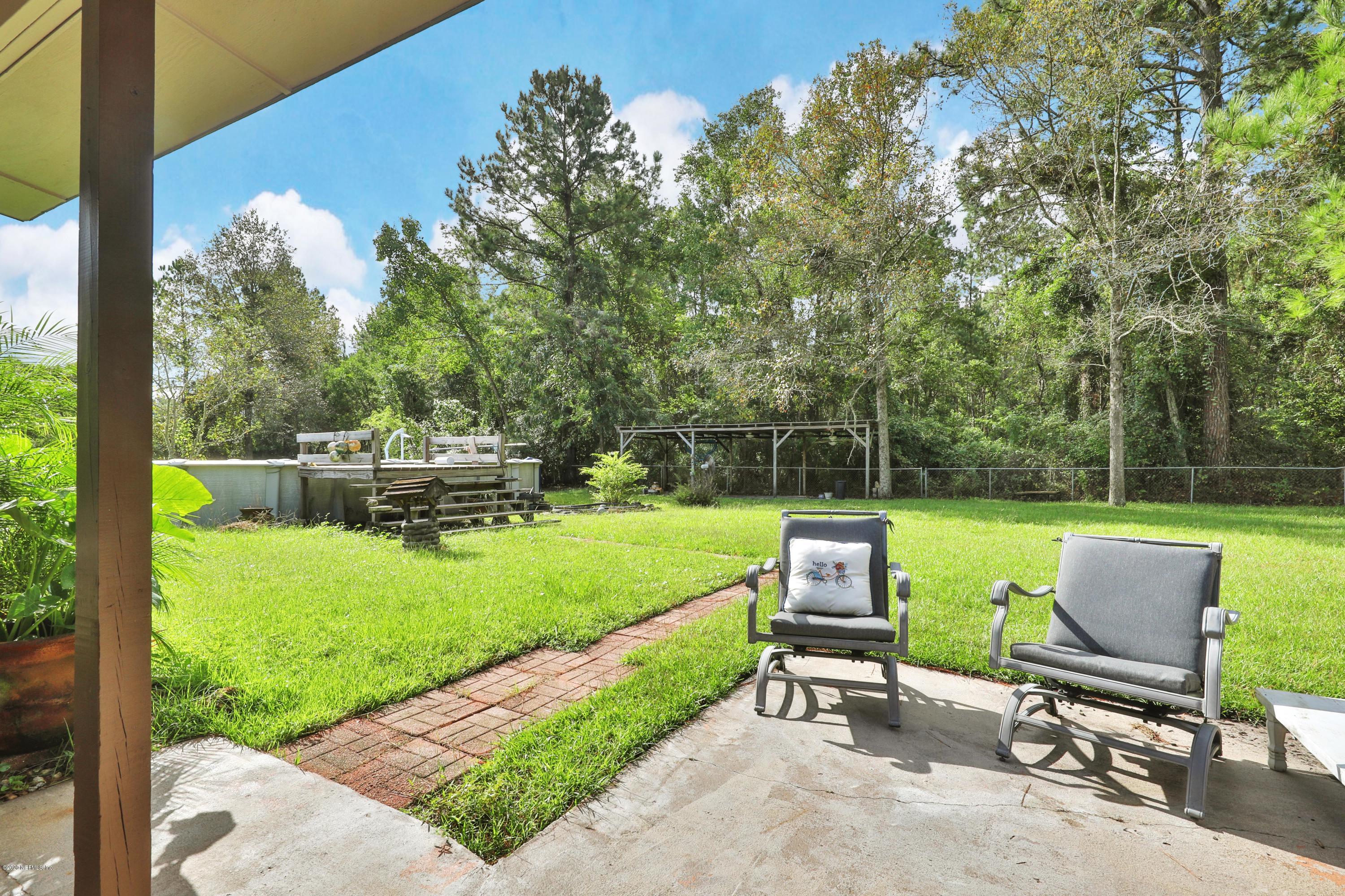 54668 Dornbush Road Callahan, FL 32011 - Photo 18 of 22 a garden with trees in the background
