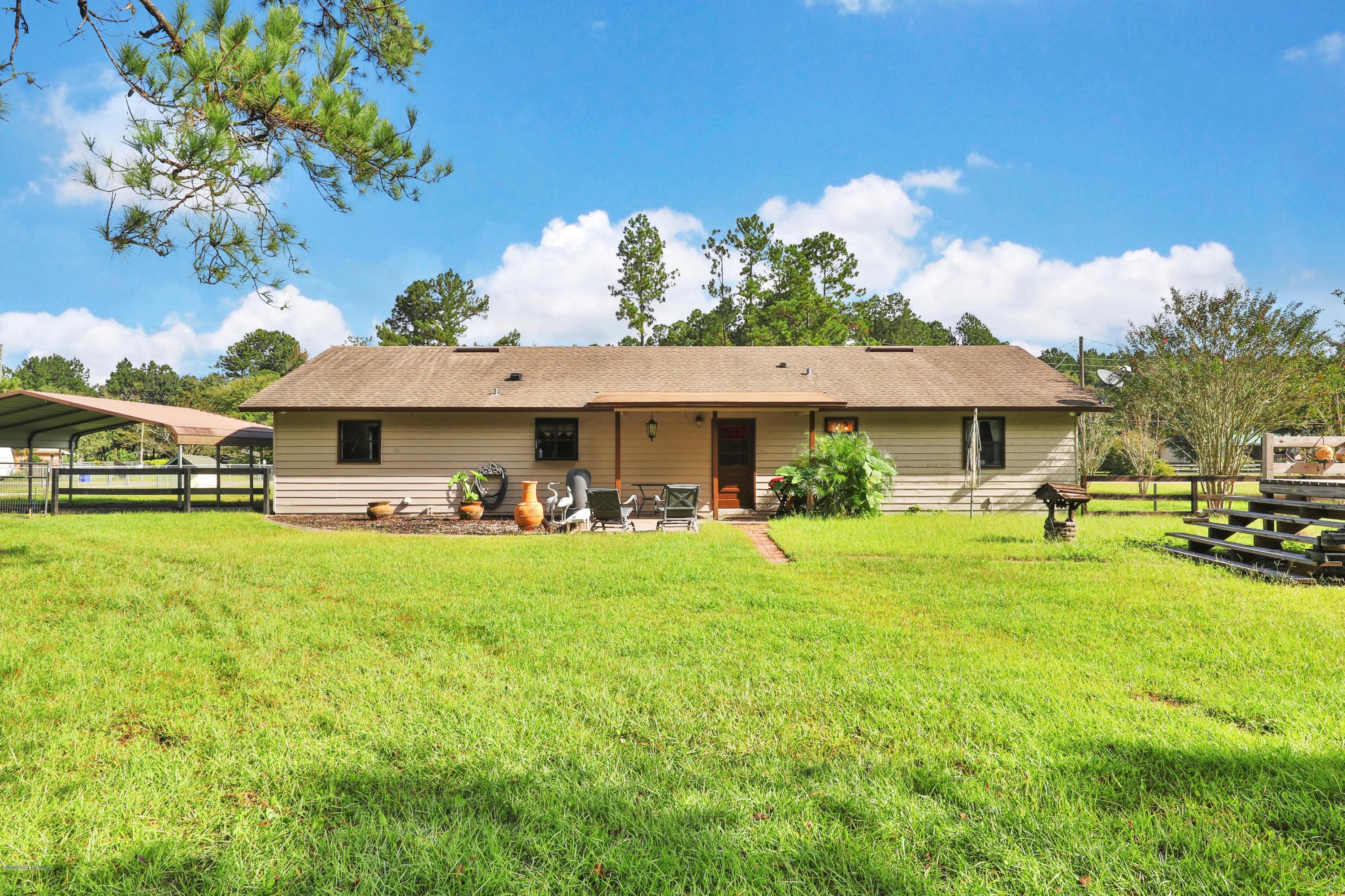 54668 Dornbush Road Callahan, FL 32011 - Photo 20 of 22 a front view of a house with a garden