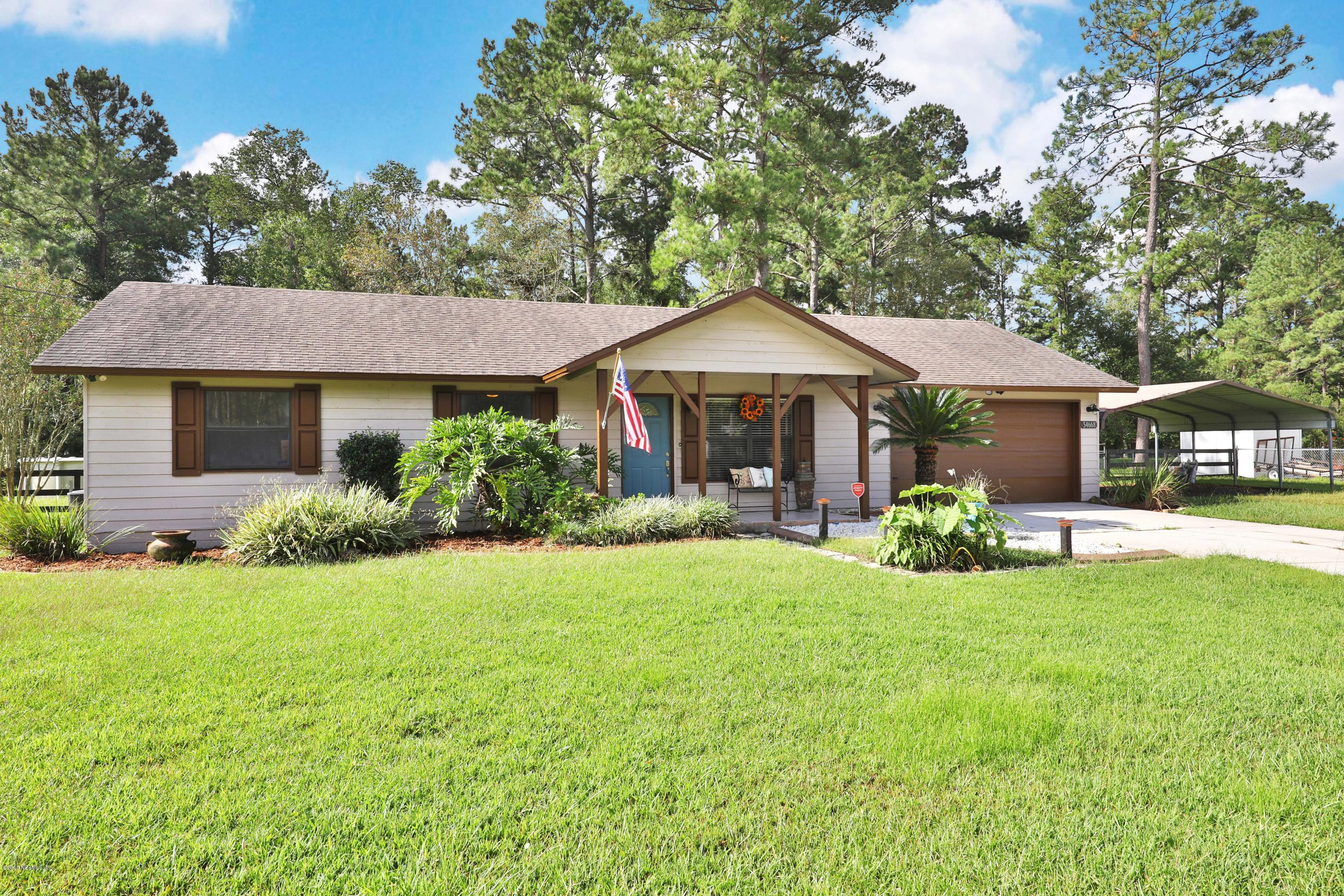 54668 Dornbush Road Callahan, FL 32011 - Photo 5 of 22 a view of a house with a yard and large trees