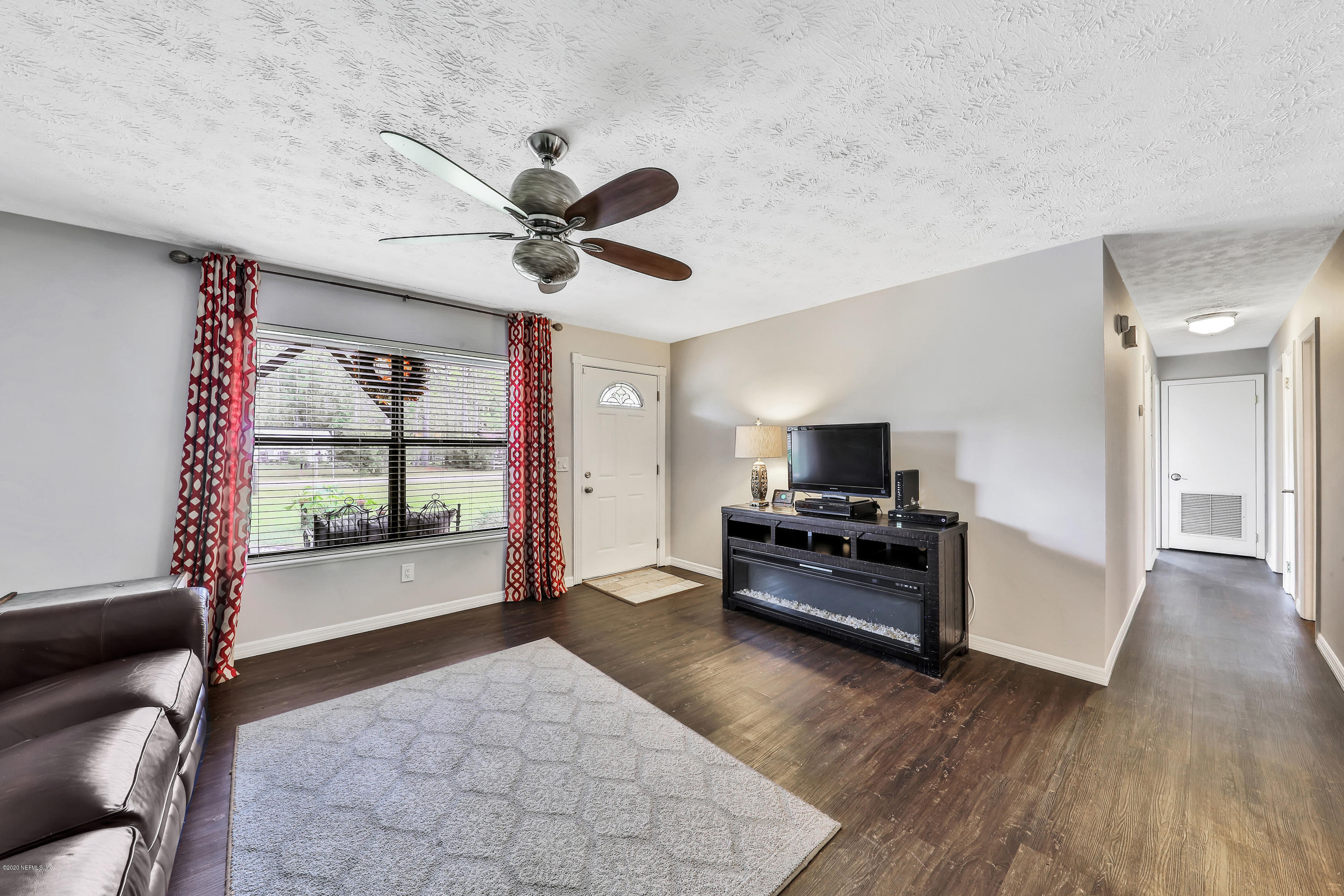 54668 Dornbush Road Callahan, FL 32011 - Photo 7 of 22 a living room with furniture and a flat screen tv