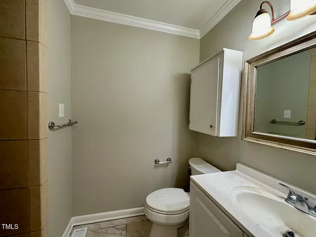 a bathroom with a sink toilet and mirror