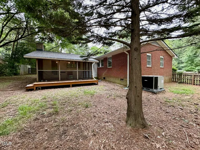 a house with a large tree in front of it