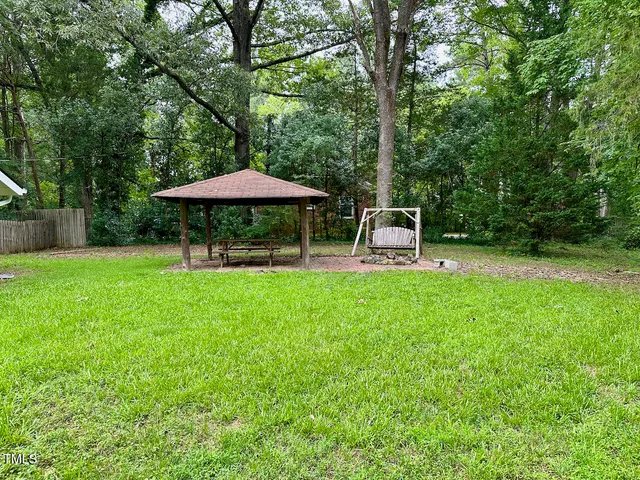 a view of a table and chairs under an umbrella