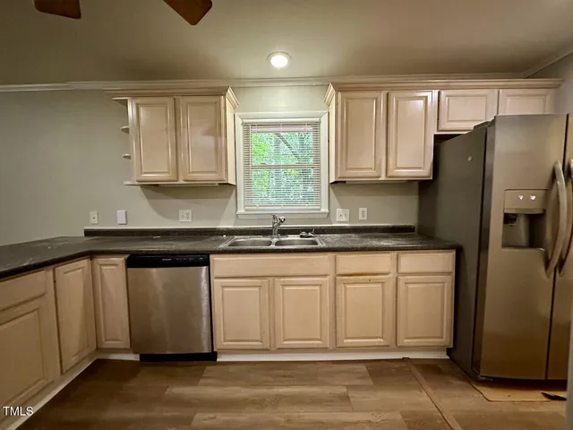 a kitchen with stainless steel appliances granite countertop a refrigerator sink and cabinets
