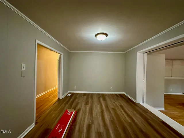 a view of room with window and wooden floor