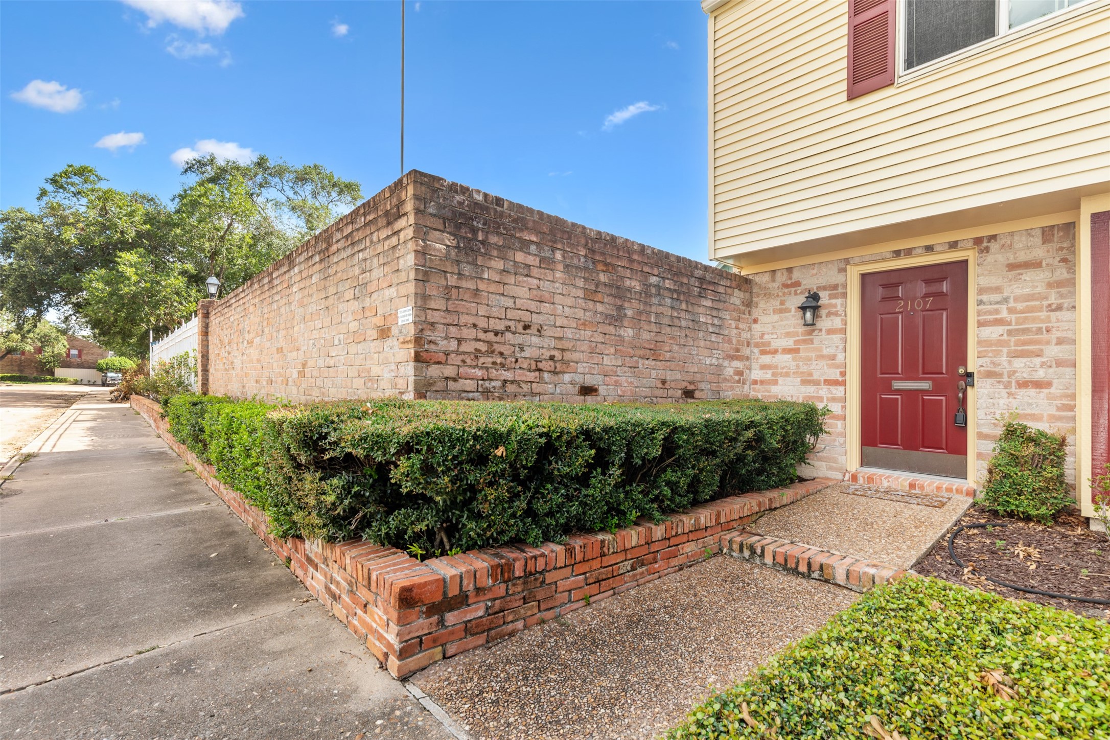 a view of a back yard with potted plants