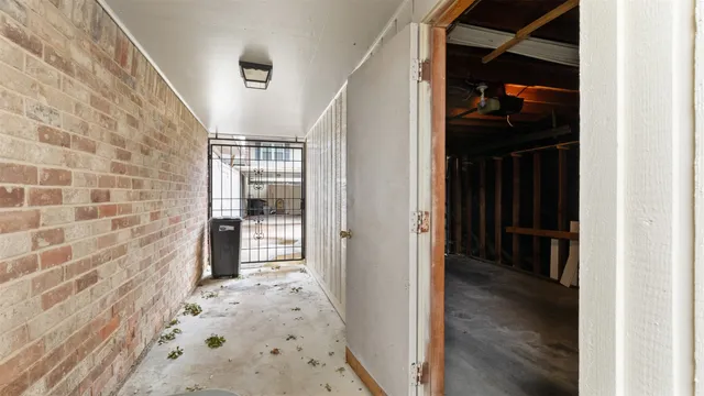 a view of hallway with wooden floor and door
