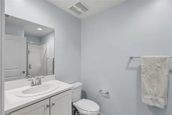 a bathroom with a sink toilet vanity and shower