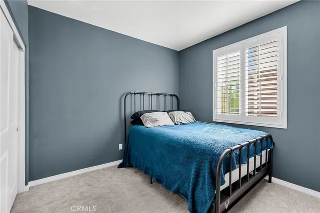 a bedroom with a bed and window