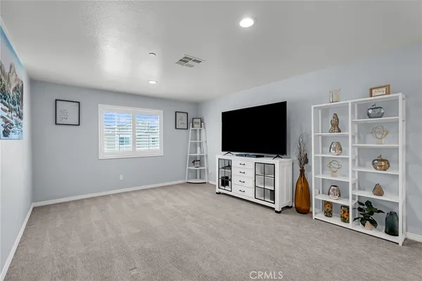 a living room with window and flat screen tv