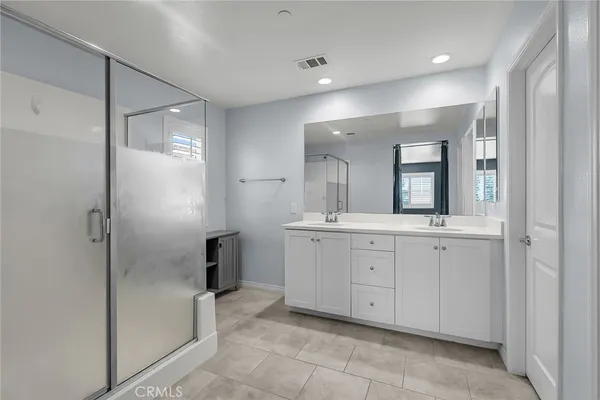 a bathroom with a granite countertop sink mirror and shower