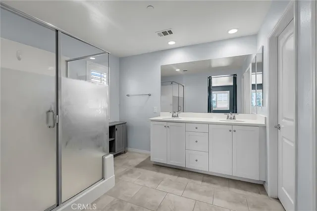 a bathroom with a granite countertop sink mirror and shower