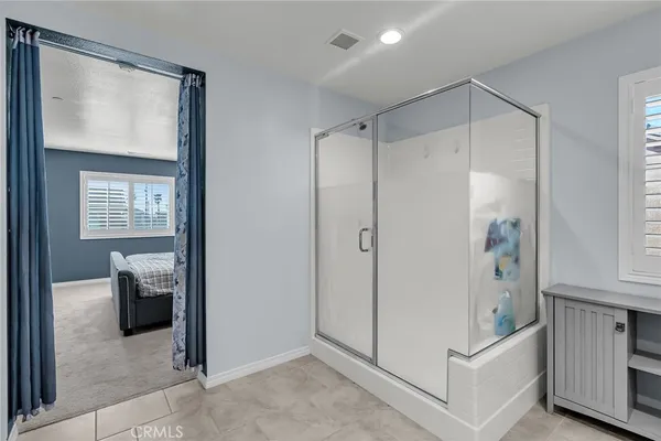 a bathroom with a shower and a sink