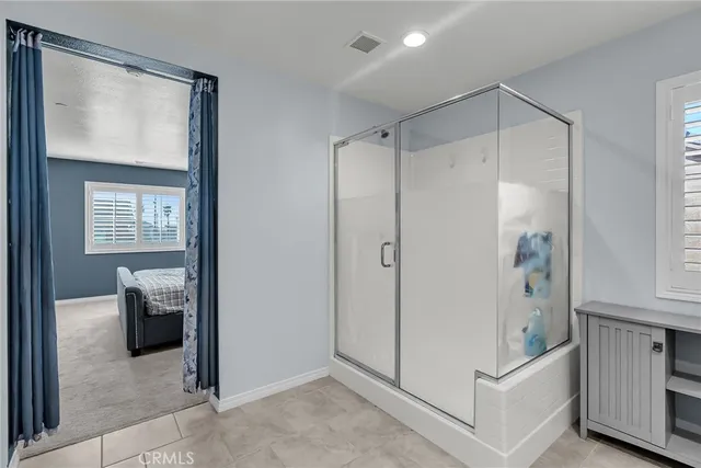 a bathroom with a shower and a sink