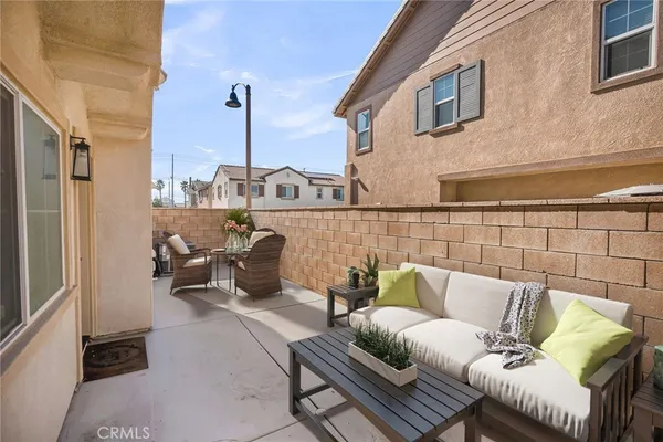 a view of a chair and table in the back yard of the house