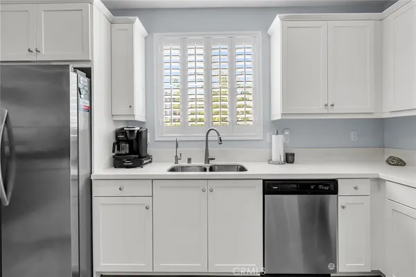 a kitchen with white cabinets and a sink