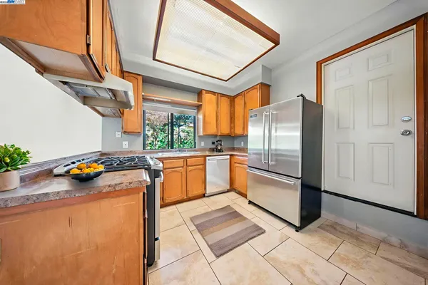 a kitchen with a refrigerator and a stove