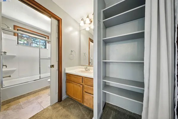 a view of walk in closet with empty racks
