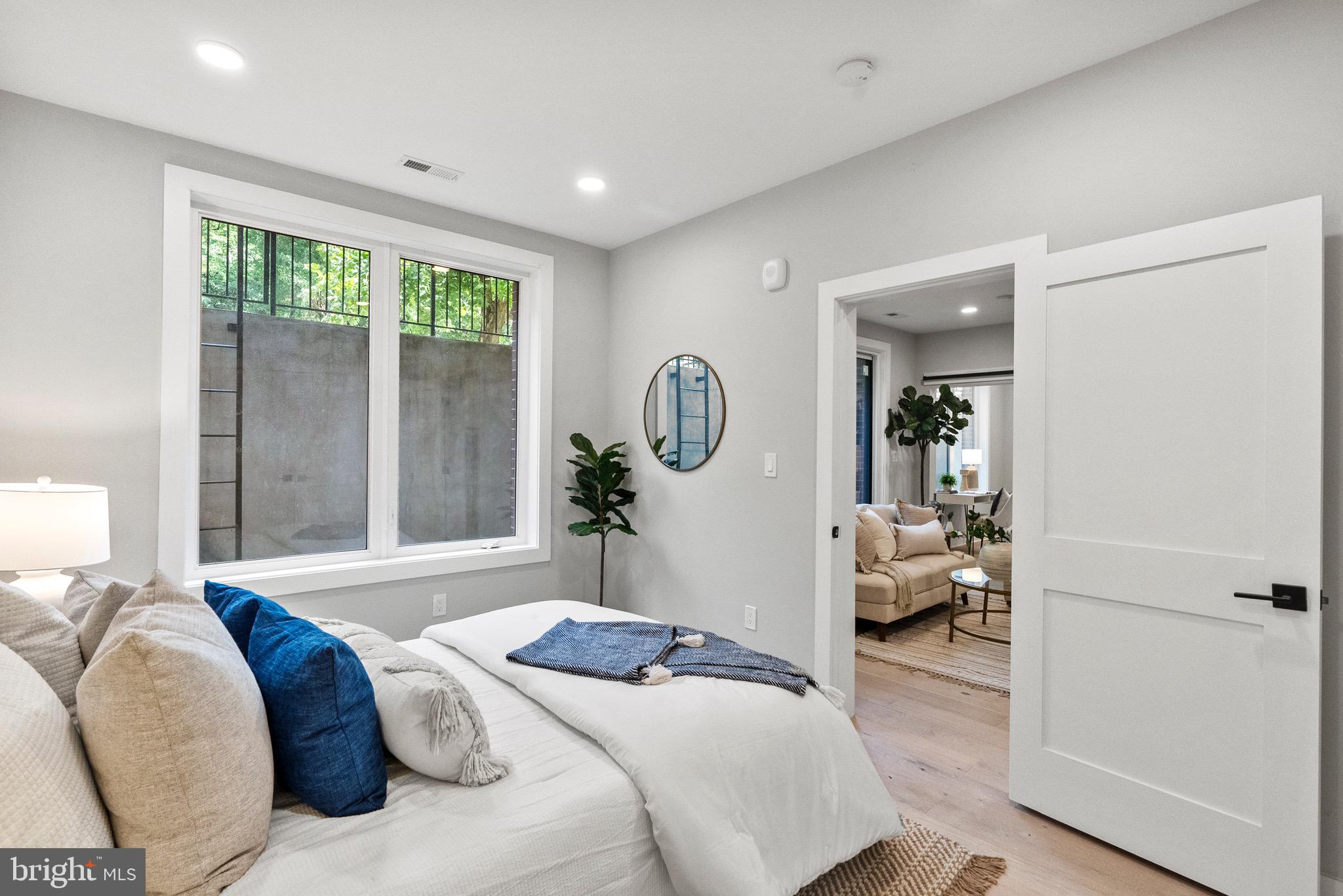 2019 M Street Northeast, Unit 1 Washington, DC 20002 - Photo 19 of 31 a bedroom with a bed and glass door