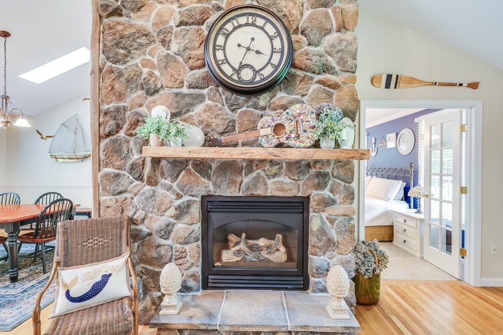 20 Courtney Road Harwich, MA 02645 - Photo 11 of 42 a stone fireplace with a clock on wall