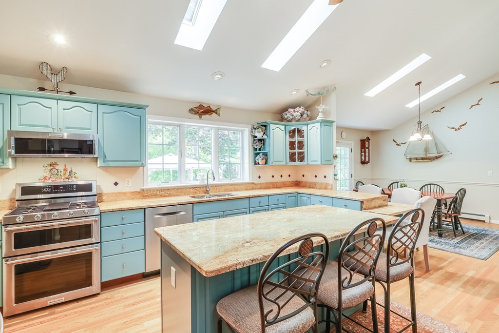 20 Courtney Road Harwich, MA 02645 - Photo 12 of 42 a kitchen with granite countertop a stove a sink and chairs