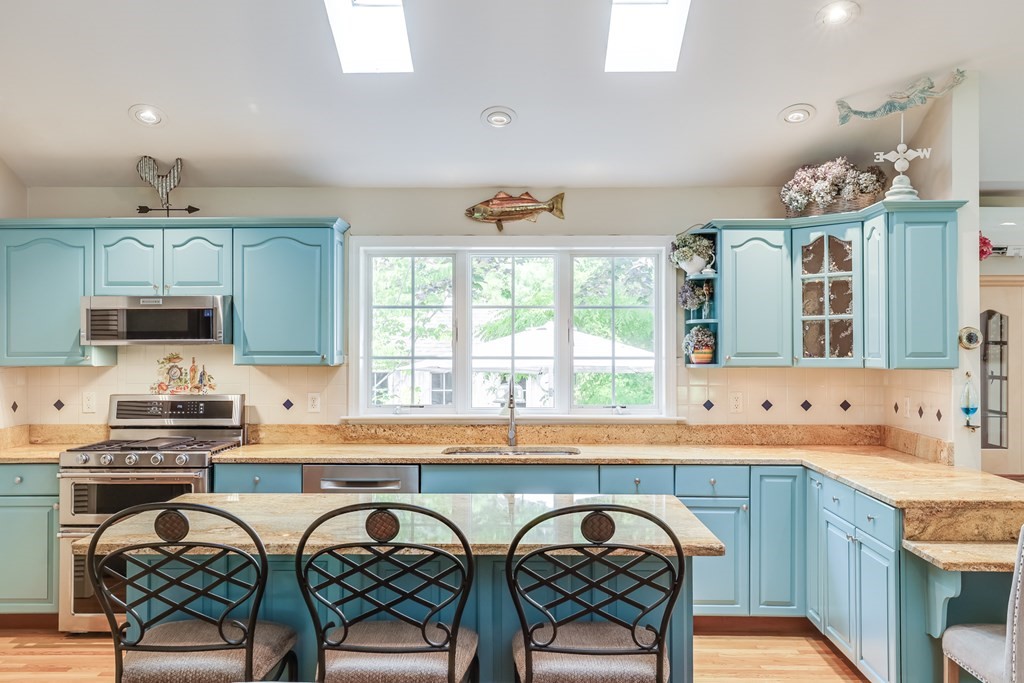 20 Courtney Road Harwich, MA 02645 - Photo 13 of 42 a kitchen with stainless steel appliances granite countertop a sink and a stove