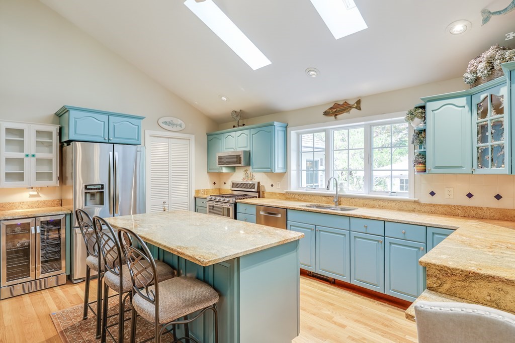 20 Courtney Road Harwich, MA 02645 - Photo 14 of 42 a kitchen with stainless steel appliances granite countertop a table chairs sink refrigerator and cabinets