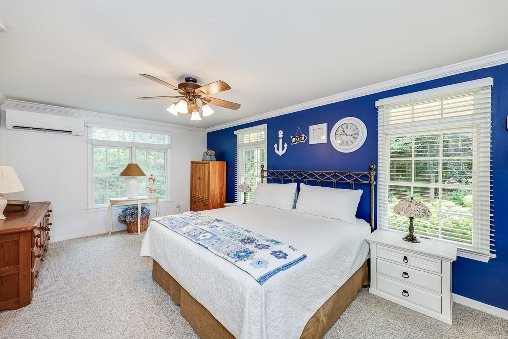 20 Courtney Road Harwich, MA 02645 - Photo 22 of 42 a bed room with a bed and a chandelier