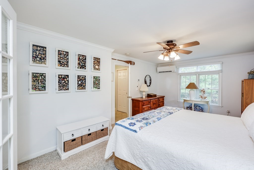20 Courtney Road Harwich, MA 02645 - Photo 23 of 42 a bedroom with a bed and a chandelier