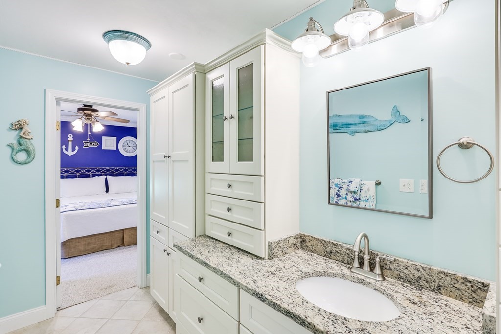 20 Courtney Road Harwich, MA 02645 - Photo 27 of 42 a bathroom with a granite countertop sink mirror and a shower