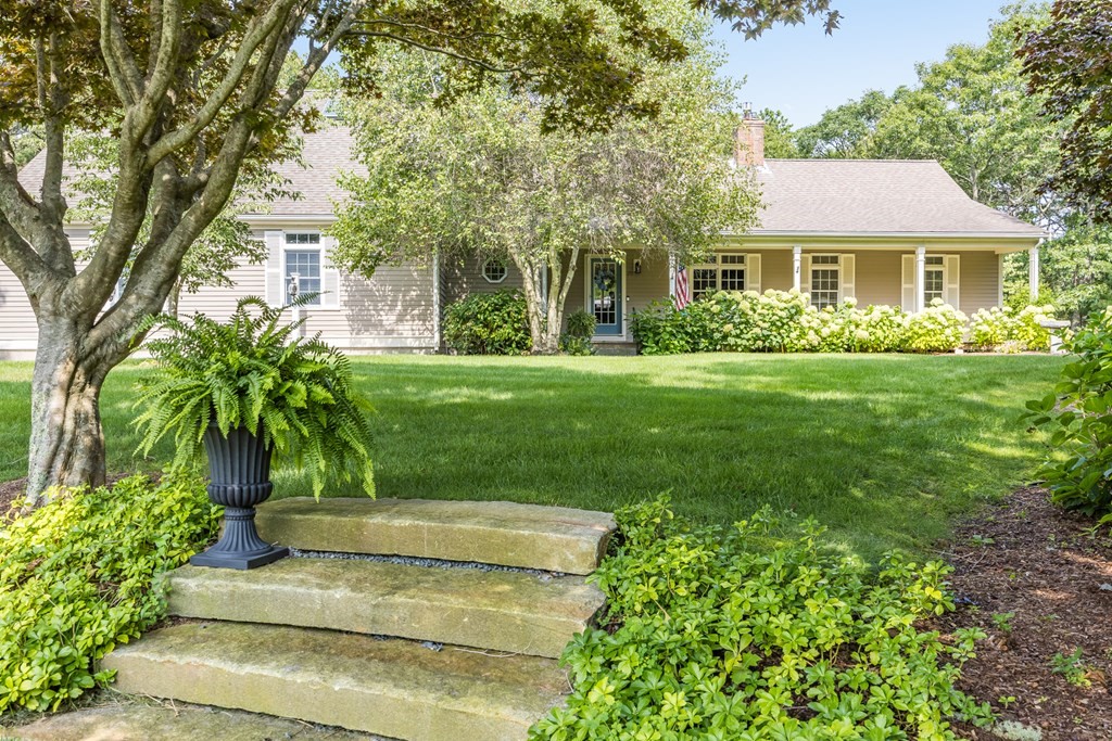 20 Courtney Road Harwich, MA 02645 - Photo 3 of 42 a front view of a house with a garden