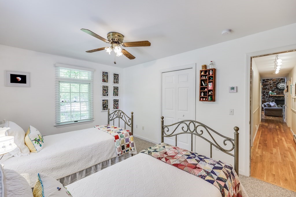 20 Courtney Road Harwich, MA 02645 - Photo 31 of 42 a bedroom with a bed and a chandelier