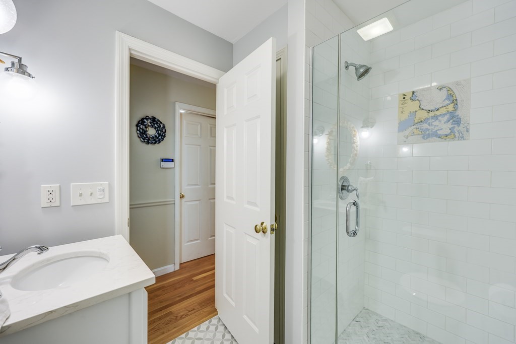 20 Courtney Road Harwich, MA 02645 - Photo 33 of 42 a bathroom with a sink and mirror with shower
