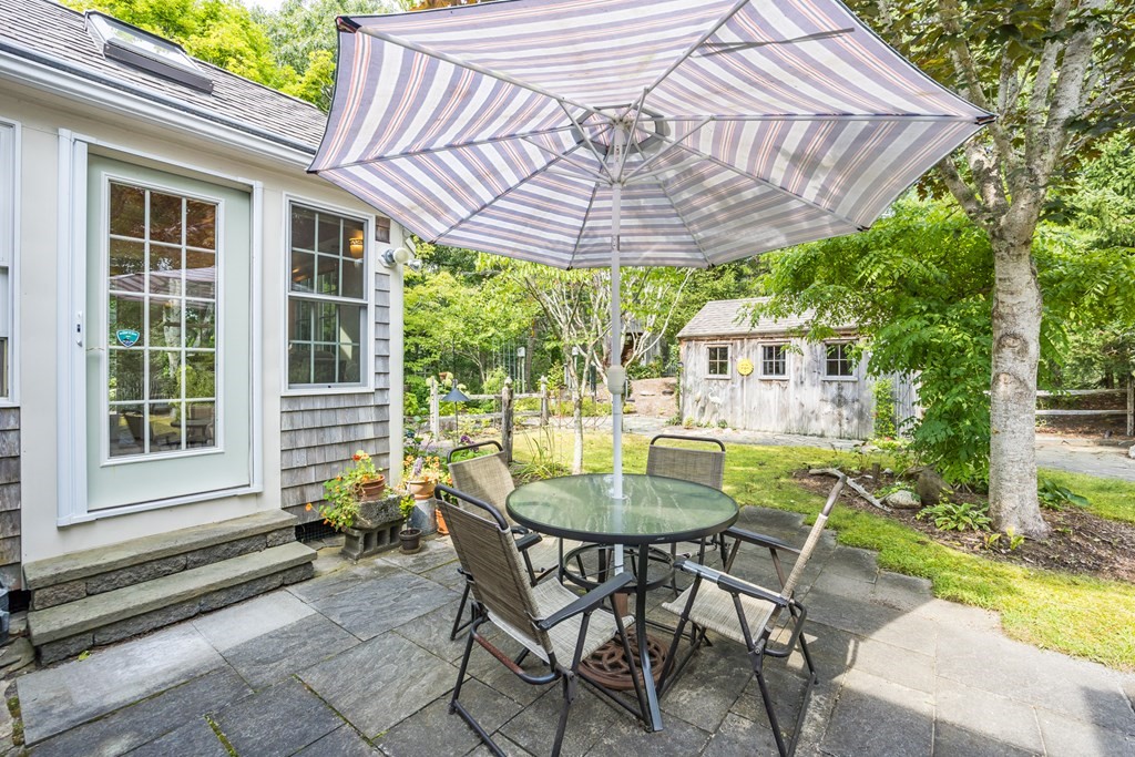 20 Courtney Road Harwich, MA 02645 - Photo 35 of 42 a patio with table and chairs and potted plants