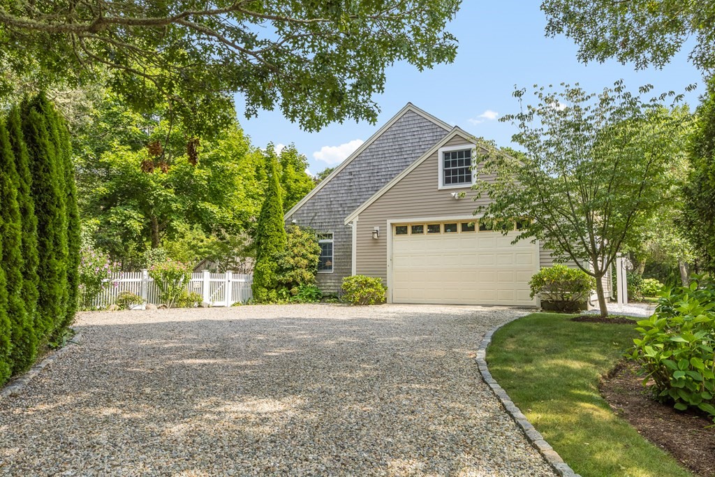 20 Courtney Road Harwich, MA 02645 - Photo 41 of 42 a front view of a house with a yard and a garage