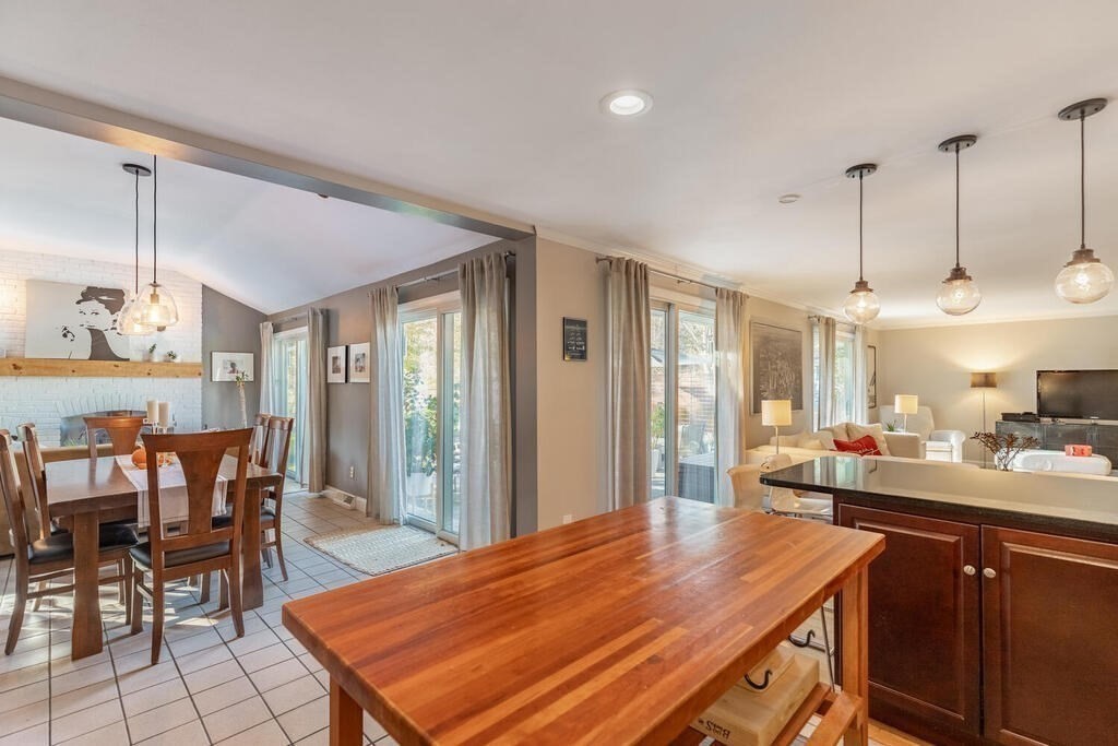 15 Forrest Road Topsfield, MA 01983 - Photo 12 of 26 a dining hall with stainless steel appliances kitchen island granite countertop a table chairs and a refrigerator
