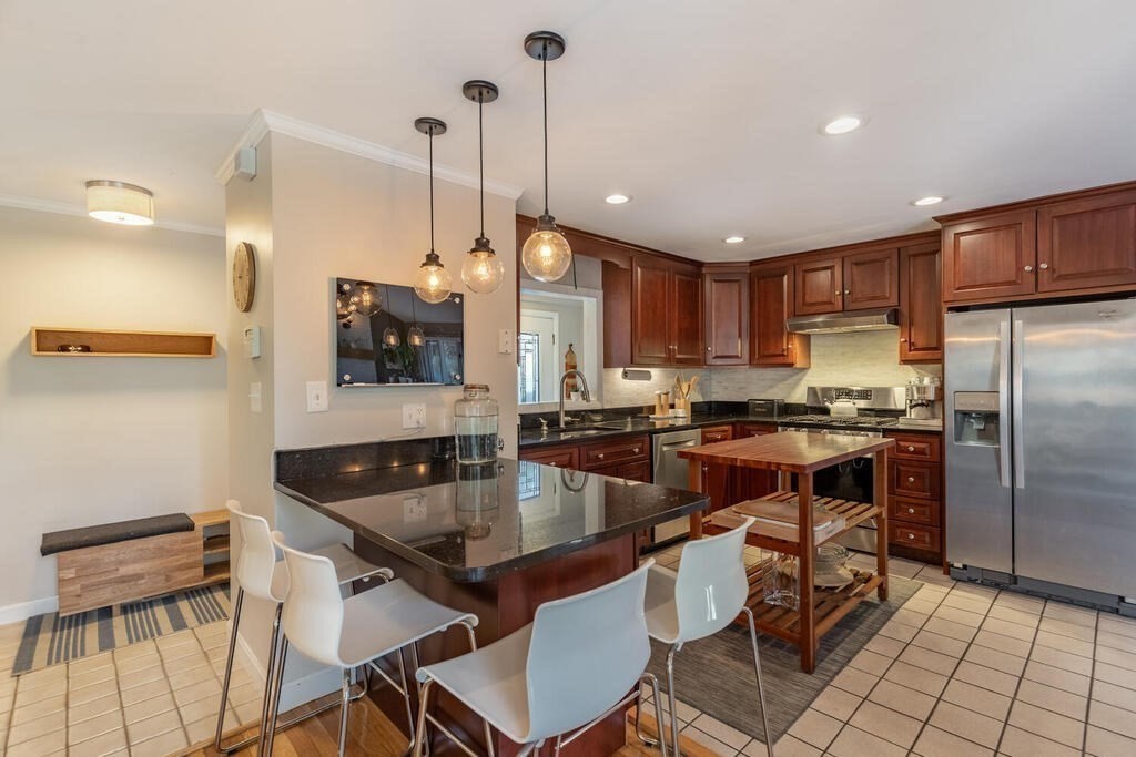 15 Forrest Road Topsfield, MA 01983 - Photo 6 of 26 a kitchen with a table chairs refrigerator and microwave