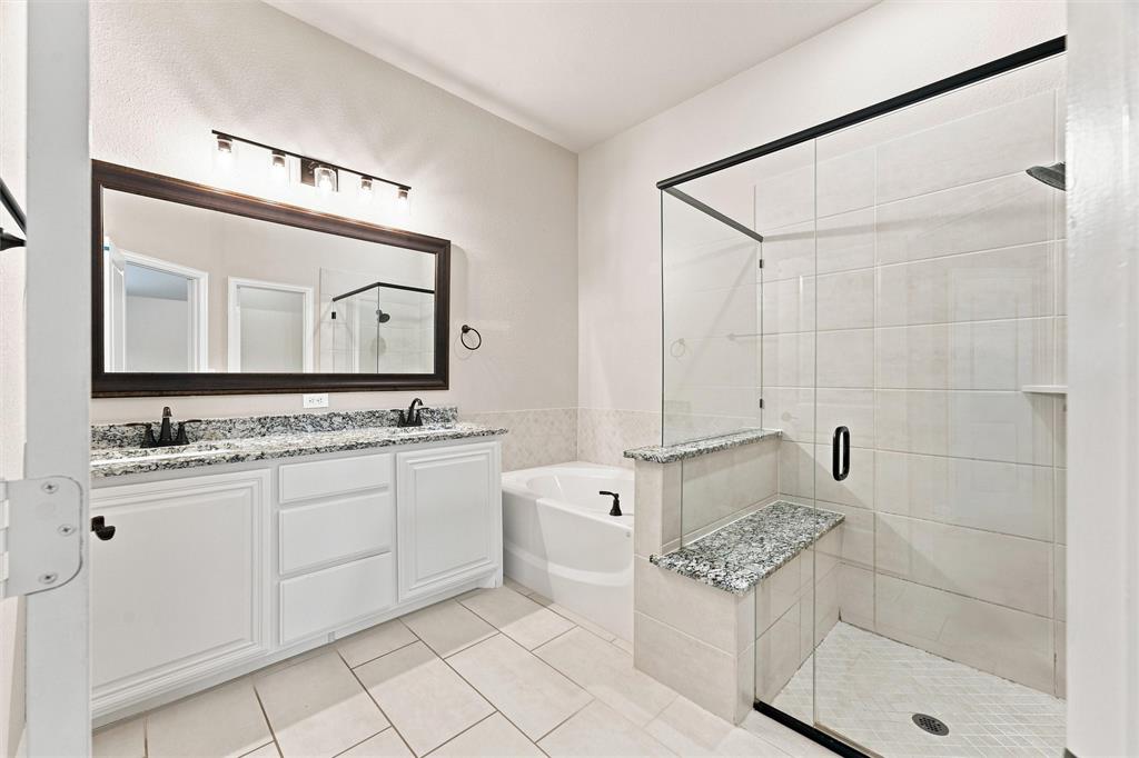 5225 Rowlan Row Midlothian, TX 76065 - Photo 19 of 33 Dual vanity with granite countertops, framed mirror, and matte black fixtures
